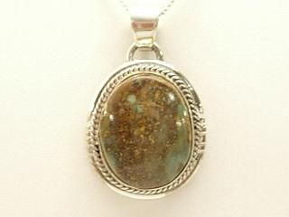 Genuine Royston Turquoise set in Sterling Silver Pendant. Beautiful Turquoise Stone. Created by Navajo Artist Bobby Piaso. Signed. The Royston Turquoise Mine is located in Nye County, Nevada.  Free 18 inch Sterling Silver Chain with purchase of pendant.
