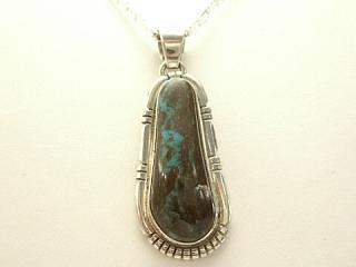 Genuine Sunnyside Turquoise set in Sterling Silver Pendant. Created by Navajo Artist Lucy Valencia. Signed LJ. The matrix on this rare stone is outstanding. The Sunnyside mine is located in northern Nevada near the town of Tuscarora in the Tuscarora mountain range. Free 18 inch Sterling Silver Chain with purchase of pendant.