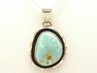 Genuine Royston Turquoise set in Sterling Silver Pendant. Beautiful Turquoise Stone. Created by Navajo Artist Emerson Delgarito. Signed. The Royston Turquoise Mine is located in Nye County, Nevada.  Free 18 inch Sterling Silver Chain with purchase of pendant.