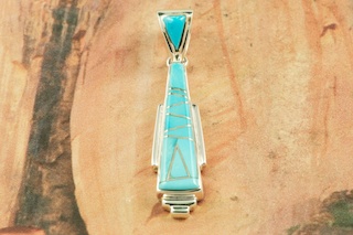 Genuine Emerald Valley Turquoise set in Sterling Silver Pendant. Created by Navajo Artist Kathy Yazzie. Signed. The Emerald Valley Mine is Located in Nevada. Free 18 inch Sterling Silver Chain with purchase of pendant.