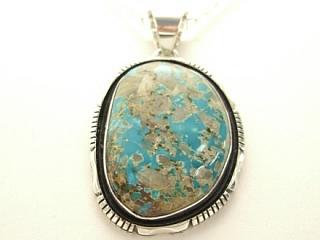 Genuine Royston Turquoise set in Sterling Silver Pendant. Stunning Turquoise Stone. Created by Navajo Artist Emerson Delgarito. Signed. The Royston Turquoise Mine is located in Nye County, Nevada.  Free 18 inch Sterling Silver Chain with purchase of pendant.