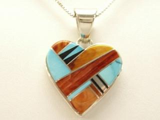 Genuine Turquoise, Spiny Oyster Shell and Black Jade inlaid between ribbons of Sterling Silver. Sterling Silver Storyteller Design on the reverse side. Free 18