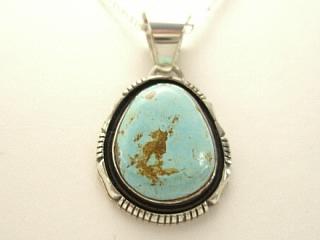 Genuine Royston Turquoise set in Sterling Silver Pendant. Beautiful Turquoise Stone. Created by Navajo Artist Emerson Delgarito. Signed. The Royston Turquoise Mine is located in Nye County, Nevada.  Free 18 inch Sterling Silver Chain with purchase of pendant.