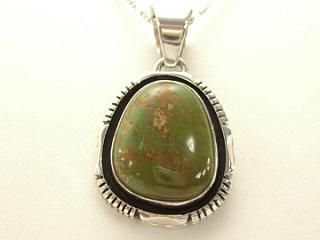 Genuine Royston Turquoise set in Sterling Silver Pendant. Beautiful Turquoise Stone. Created by Navajo Artist Emerson Delgarito. Signed. The Royston Turquoise Mine is located in Nye County, Nevada.  Free 18 inch Sterling Silver Chain with purchase of pendant.