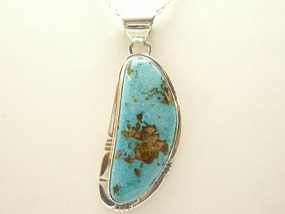 Genuine Pilot Mountain Turquoise set in Sterling Silver Pendant. Created by Navajo Artist Phillip Sanchez. Signed. Free 18 inch Sterling Silver Chain with purchase of pendant. The Pilot Mountain mine is located in Esmeralda County, Nevada.