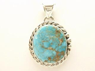 Genuine Pilot Mountain Turquoise set in Sterling Silver Pendant. Created by Navajo Artist Tony Garcia. Signed. Free 18 inch Sterling Silver Chain with purchase of pendant. The Pilot Mountain mine is located in Esmeralda County, Nevada.