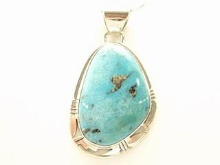 Genuine Sunnyside Turquoise set in Sterling Silver Pendant. Created by Navajo Artist Phillip Sanchez. Signed. The matrix on this rare stone is outstanding. The Sunnyside mine is located in northern Nevada near the town of Tuscarora in the Tuscarora mountain range. Free 18 inch Sterling Silver Chain with purchase of pendant. 