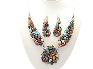 Authentic Native American Jewelry. Genuine Gemstones set in Sterling Silver. Featuring Genuine Turquoise, Blue Lapis, Howlite, Spiny Oyster Shell, Coral and Black Onyx. Sterling Silver Chain and Clasp. created by Navajo Artist Gilbert Johnson. Signed.