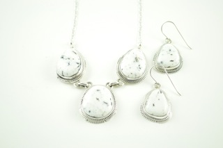 Genuine White Buffalo Turquoise set in Sterling Silver. This Beautiful Stone is formed from the minerals Calcite and Iron. It is mined near Tonopah Nevada. Beautiful Necklace and Earrings Set. The photo is of the jewelry you will be receiving. Created by Navajo Artist Lucy Valencia. Signed.  