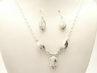 Genuine White Buffalo Turquoise set in Sterling Silver. This Beautiful Stone is formed from the minerals Calcite and Iron. It is mined near Tonopah Nevada. Beautiful Necklace and Earrings Set. The photo is of the jewelry you will be receiving. Created by Navajo Artist Lucy Valencia. Signed.  