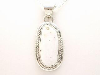 Genuine White Buffalo Turquoise set in Sterling Silver. This Beautiful Stone is formed from the minerals Calcite and Iron. It is mined near Tonopah Nevada. This Beautiful Pendant and Earring Set is a one of a kind Set. The photo is of the jewelry you will be receiving. Created by Navajo Artist Larson Lee. Signed. Free 18 inch Sterling Silver Chain with purchase. 
