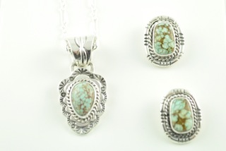 Genuine Number 8 Mine Turquoise Stones set in Sterling Silver. Beautiful Necklace and Earrings Set. The photo is of the jewelry you will be receiving. Created by Navajo Artist Lucy Valencia. Signed. The Number 8 mine is located in Eureka County Nevada. Since 1976 there has been no Number 8 Turquoise mined. There is however, an existing stock pile that Mr. Dowell Ward, the last owner of the Number 8 mine, had stocked away for later sorting. The Turquoise is a collector's item--because once the reserve is gone there will be no more material released onto the market. The Gold Mining Company owns the claim to the Number 8 mine and it has been swallowed up by the gold mining operations. This is some of the last Number 8 Turquoise to be had and will be a great addition to your collection. 
