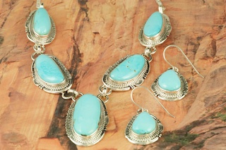 Genuine Castle Dome Turquoise set in Sterling Silver. Stunning Necklace and Earrings Set. The Castle Dome Turquoise Mine is located about 30 miles from the Sleeping Beauty Mine, near Globe, Arizona. The Castle Dome Mine has not been in operation since the early 1970s. The photo is of the jewelry you will be receiving. Created by Navajo Artist John Nelson. Signed by the artist.
