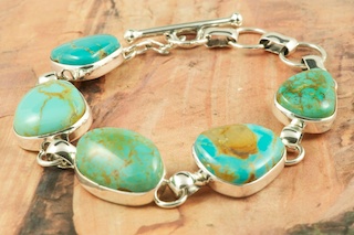 Stunning Bracelet featuring Five Genuine Manassa Turquoise Stones set in Sterling Silver. This Turquoise is also referred to as King�s Manassa Turquoise. The Manassa Turquoise mine is located in Manassa, Conejos County, Colorado. Created by Navajo Artist Tony Garcia.