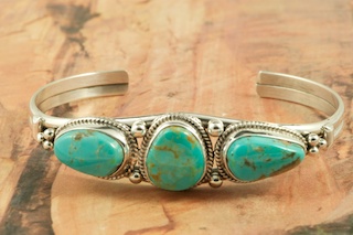 Genuine Manassa Turquoise set in Sterling Silver Bracelet. This Turquoise is also referred to as King�s Manassa Turquoise. The Manassa Turquoise mine is located in Manassa, Conejos County, Colorado. Created by Navajo Artist Lucy Valencia. Signed L. J. by the artist.