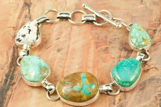 Genuine Assorted Gemstones set in Sterling Silver Bracelet. Featuring Genuine  White Buffalo Turquoise, Royston Turquoise, Boulder Turquoise, Fox Turquoise and Number 8 Mine Turquoise. The photo is of the jewelry you will be receiving. Created by Navajo Artist Tony Garcia. Signed by the artist.