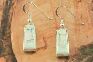 Stunning Fire and Ice Lab Opals inlaid between ribbons of Sterling Silver. Beautiful Sterling Silver French Wire Earrings feature precision channel inlay. Designed by Navajo Artist Calvin Begay. Signed by the artist..