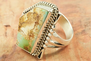 Mother Nature is Amazing! The beautiful pattern in the stone (called the matrix) is all natural. Genuine Royston Turquoise set in Sterling Silver Ring. The Royston Turquoise Mine was originally known as the Royal Blue Mine. It produces Turquoise that has a mixture of blues and greens in the same formation. The Royston Turquoise Mine is located in Nye County, Nevada. Created by Navajo Artist Justin Morris. Signed by the artist.