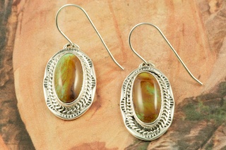 Genuine Manassa Turquoise set in Sterling Silver French Wire Earrings. This Turquoise is also referred to as King�s Manassa Turquoise. The Manassa Turquoise mine is located in Manassa, Conejos County, Colorado. Created by Navajo Artist B. J. Piaso. Signed by the artist.