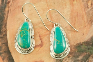 Genuine Manassa Turquoise set in Sterling Silver French Wire Earrings. This Turquoise is also referred to as King�s Manassa Turquoise. The Manassa Turquoise mine is located in Manassa, Conejos County, Colorado. Created by Navajo Artist Lucy Valencia. Signed L. J. by the artist.
