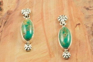 Genuine Manassa Turquoise set in Sterling Silver Post Earrings. This Turquoise is also referred to as King�s Manassa Turquoise. The Manassa Turquoise mine is located in Manassa, Conejos County, Colorado. Created by Navajo Artist Arkie Nelson. Signed by the artist.