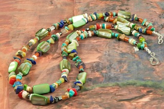 Stunning 2 Strand Treasure Necklace with Genuine Assorted Gemstones. Featuring Genuine  Abalone Shell, Turquoise, Coral, Blue Lapis, Red Jasper and Spiny Oyster Shell.  Sterling Silver Beads, Cones and Clasp. Created by Santo Domingo Artist Carol Pacheco. The Santo Domingo Pueblo is in New Mexico, near Santa Fe.