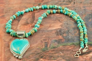 Stunning Pendant and Necklace Set featuring Genuine Manassa Turquoise set in Sterling Silver. This Turquoise is also referred to as King�s Manassa Turquoise. The Manassa Turquoise mine is located in Manassa, Conejos County, Colorado. Created by Navajo Artist Lucy Valencia. Signed L. J. by the artist.