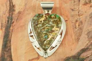 Genuine Sunnyside Turquoise set in Sterling Silver Pendant. Created by Navajo Artist Phillip Sanchez. Signed by the artist. The matrix on this rare stone is outstanding. The Sunnyside mine is located in northern Nevada near the town of Tuscarora in the Tuscarora mountain range. Free 18 inch Sterling Silver Chain with purchase of pendant.