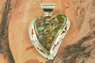Genuine Sunnyside Turquoise set in Sterling Silver Pendant. Created by Navajo Artist Phillip Sanchez. Signed by the artist. The matrix on this rare stone is outstanding. The Sunnyside mine is located in northern Nevada near the town of Tuscarora in the Tuscarora mountain range. Free 18 inch Sterling Silver Chain with purchase of pendant.
