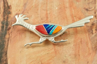 Beautiful Roadrunner Brooch featuring Genuine Turquoise, Spiny Oyster Shell and Black Jade inlaid in Sterling Silver. Accented with Fire and Ice Lab Opals. Designed by Navajo Artist Calvin Begay. Signed by the artist.