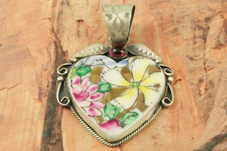 Blue Plate Special! Hand Cut Ceramic from Collectable Plates set in Sterling Silver Pendant with an Antique Satin finish. Accented with a Beautiful Amethyst Stone. Created by Navajo Artist Martha Willeto. Signed by the artist. Free 18 inch Sterling Silver Chain with purchase of pendant.