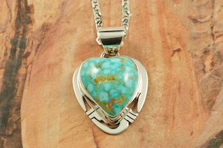 Genuine High Grade Kingman Web Turquoise set in Sterling Silver Pendant. Created by Navajo Artist Phillip Sanchez. Signed by the artist. The Mineral Park Mine, in the Cerbat Mountains 14 miles northwest of Kingman, was first mined by Indians centuries before white man came to the area. It is one of the three sites of prehistoric mining localities in the state of Arizona. Mineral Park was the most extensively worked area by the Indians of the three. S.A. �Chuck� Colbaugh found a cache of stone hammers uncovered in ancient trenches and tunnels, when he had the turquoise mining concession in May of 1962. Ithaca Peak and Turquoise Mine (formally called Aztec Mountain or Aztec Peak) are the most famous of the peaks in the area containing turquoise. Free 18