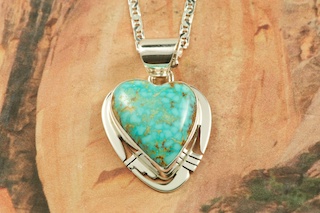 Genuine High Grade Kingman Web Turquoise set in Sterling Silver Pendant. Created by Navajo Artist Philip Sanchez. Signed by the artist. The Mineral Park Mine, in the Cerbat Mountains 14 miles northwest of Kingman, was first mined by Indians centuries before white man came to the area. It is one of the three sites of prehistoric mining localities in the state of Arizona. Mineral Park was the most extensively worked area by the Indians of the three. S.A. �Chuck� Colbaugh found a cache of stone hammers uncovered in ancient trenches and tunnels, when he had the turquoise mining concession in May of 1962. Ithaca Peak and Turquoise Mine (formally called Aztec Mountain or Aztec Peak) are the most famous of the peaks in the area containing turquoise. Free 18
