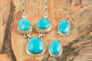 Genuine Castle Dome Turquoise set in Sterling Silver. Stunning Necklace and Earrings Set. The Castle Dome Turquoise Mine is located about 30 miles from the Sleeping Beauty Mine, near Globe, Arizona. The Castle Dome Mine has not been in operation since the early 1970s. The photo is of the jewelry you will be receiving. Created by Navajo Artist Lucy Valencia. Signed L. J. by the artist.