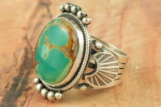 Genuine Manassa Turquoise set in Sterling Silver Ring. This Turquoise is also referred to as King�s Manassa Turquoise. The Manassa Turquoise mine is located in Manassa, Conejos County, Colorado. Created by Navajo Artist Aaron Toadlena. Signed by the artist.