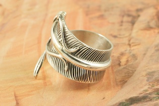 Genuine High Grade Kingman Web Turquoise set in Sterling Silver Ring. Created by Navajo Artist Lucy Valencia. Signed by the artist. The Mineral Park Mine, in the Cerbat Mountains 14 miles northwest of Kingman, was first mined by Indians centuries before white man came to the area. It is one of the three sites of prehistoric mining localities in the state of Arizona. Mineral Park was the most extensively worked area by the Indians of the three. S.A. �Chuck� Colbaugh found a cache of stone hammers uncovered in ancient trenches and tunnels, when he had the turquoise mining concession in May of 1962. Ithaca Peak and Turquoise Mine (formally called Aztec Mountain or Aztec Peak) are the most famous of the peaks in the area containing turquoise.