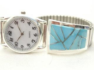 Genuine Sleeping Beauty Turquoise inlaid between ribbons of Sterling Silver.  Mens quartz watch with expandable band. Created by Navajo Artist Calvin Begay. Signed.