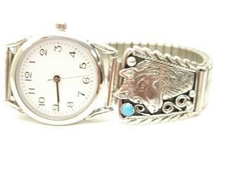 Genuine Sleeping Beauty Turquoise set in Sterling Silver Watch Tips. Sterling Silver Wolf design. Mens Watch with expandable band. Created by Navajo Artist Thomas Chischilly. Signed.