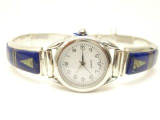 Stunning Watch Bracelet with Genuine Sleeping Beauty Turquoise, Spider Web Turquoise, Spiny Oyster Shell and Blue Lapis inlaid between ribbons of Sterling Silver. Created by Navajo Artist Calvin Begay. Signed. 