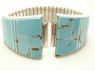 Genuine Turquoise inlaid between ribbons of Sterling Silver. Watch Tip with expandable band. Created by Navajo Artist Larry Yazzie. 