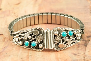 Genuine Sleeping Beauty Turquoise set in Sterling Silver. Beautiful Kokopelli Design. Ladies Watch Tips with expandable band. Created by Navajo Artist Tony Garcia. Signed.