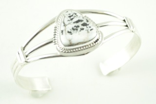 White Buffalo Turquoise set in heavy gauge Sterling Silver Bracelet. This Beautiful Stone is formed from the minerals Calcite and Iron. It is mined near Tonopah Nevada. Created by Navajo Artist Margaret Platero. Signed.
