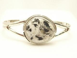 White Buffalo Turquoise set in heavy gauge Sterling Silver Bracelet. This Beautiful Stone is formed from the minerals Calcite and Iron. It is mined near Tonopah Nevada. Created by Navajo Artist Kathy Yazzie. Signed.