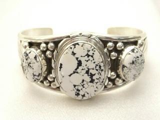 Authentic Native American Jewelry. Beatiful White Buffalo Turquoise Set in heavy gauge Sterling Silver. This Beautiful Stone is formed from the minerals Calcite and Iron. It is mined near Tonopah Nevada.  Created by Navajo Artist Edison Etsitty. Signed.