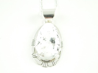 White Buffalo Turquoise and Black Jade inlaid in Sterling Silver Feather Pendant. This Beautiful Stone is formed from the mineral Magnesite. It is mined near Elko Nevada. Created by Navajo Artist Calvin Begay. Signed. Free 18" Sterling Silver Chain with purchase of pendant.




