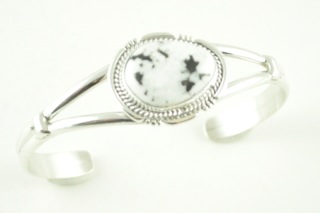 White Buffalo Turquoise set in heavy gauge Sterling Silver Bracelet. This Beautiful Stone is formed from the minerals Calcite and Iron. It is mined near Tonopah Nevada. Created by Navajo Artist Larson Lee. Signed.