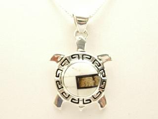 White Buffalo Turquoise, Piture Jasper and Black Jade inlaid between ribbons of Sterling Silver Turtle Pendant. This Beautiful Stone is formed from the mineral Magnesite. It is mined near Elko Nevada. Designed by Navajo Artist Calvin Begay. Signed. Free 18 