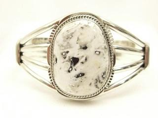 White Buffalo Turquoise set in heavy gauge Sterling Silver Bracelet. This Beautiful Stone is formed from the minerals Calcite and Iron. It is mined near Tonopah Nevada. Created by Navajo Artist Margaret Platero. Signed.

