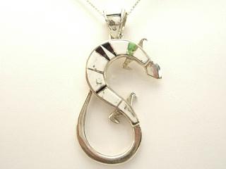 Authentic Native American Jewelry. White Buffalo Turquoise and Jet inlaid between ribbons of Sterling Silver. Beautiful Turtle Pendant. This Beautiful Stone is formed from the mineral Magnesite. It is mined near Elko Nevada. Created by Navajo Artist Calvin Begay and Joanna Charlie. Free 18 