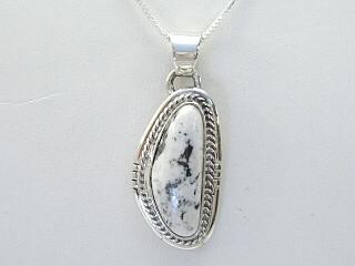 White Buffalo Turquoise set in Sterling Silver Pendant. This Beautiful Stone is formed from the minerals Calcite and Iron. It is mined near Tonopah Nevada. Free 18" Sterling Silver Chain with Purchase of Pendant. Created by Navajo Artist Bobby Piaso. Signed 

